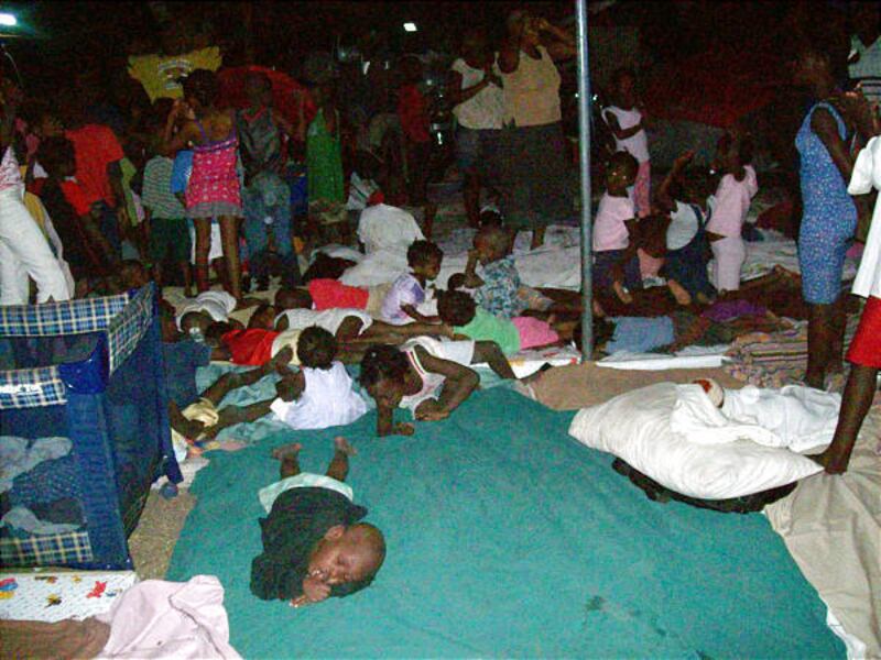 Children and staff camp in the courtyard at Maison des Enfants de Dieu orphanage in Port-au-Prince Thursday.
