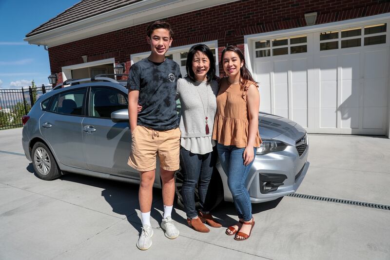 Julie Langie poses for a photo with her children, Chris, 15, and Emily, 18, at their home in Draper on Saturday, May 25, 2019.
