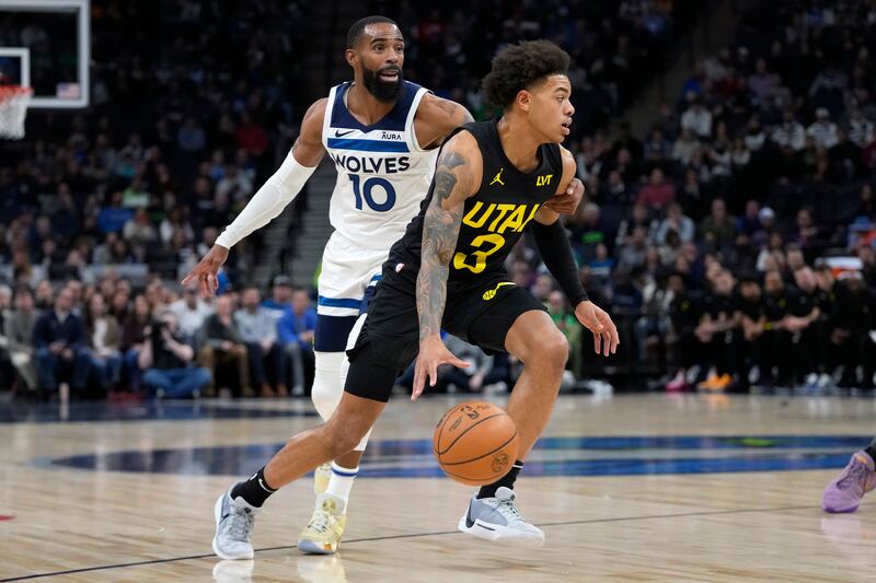 Utah Jazz guard Keyonte George (3) works toward the basket as Minnesota Timberwolves guard Mike Conley (10) defends during the first half of an NBA basketball game Thursday, Nov. 30, 2023, in Minneapolis.