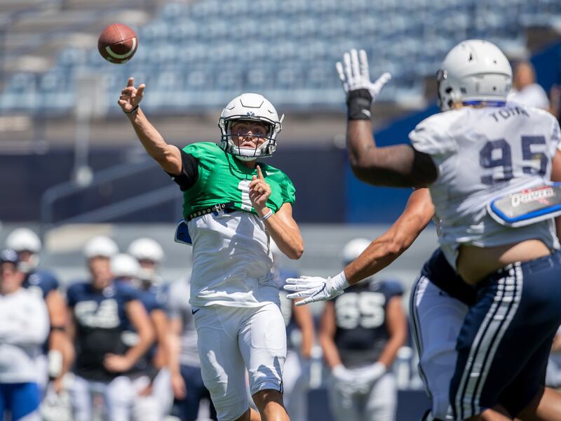 BYU quarterback Zach Wilson (1) passes the ball as defensive tackle Khyiris Tonga defends during the Cougars’ practice Wednesday, Aug. 21, 2019 at LaVell Edwards Stadium in Provo.