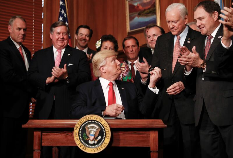 President Donald Trump hands a pen to Sen. Orrin Hatch, R-Utah, after signing an Antiquities Executive Order during a ceremony at the Interior Department in Washington, Wednesday, April, 26, 2017. The president is asking for a review of the designation of