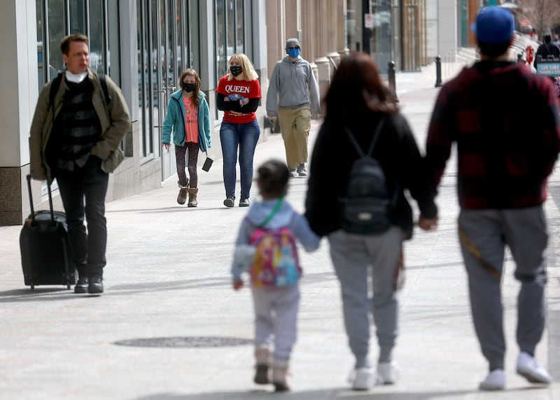 MabelAnn Moses and her sister, Atlantis Moses, and others wear masks while walking in downtown Salt Lake City