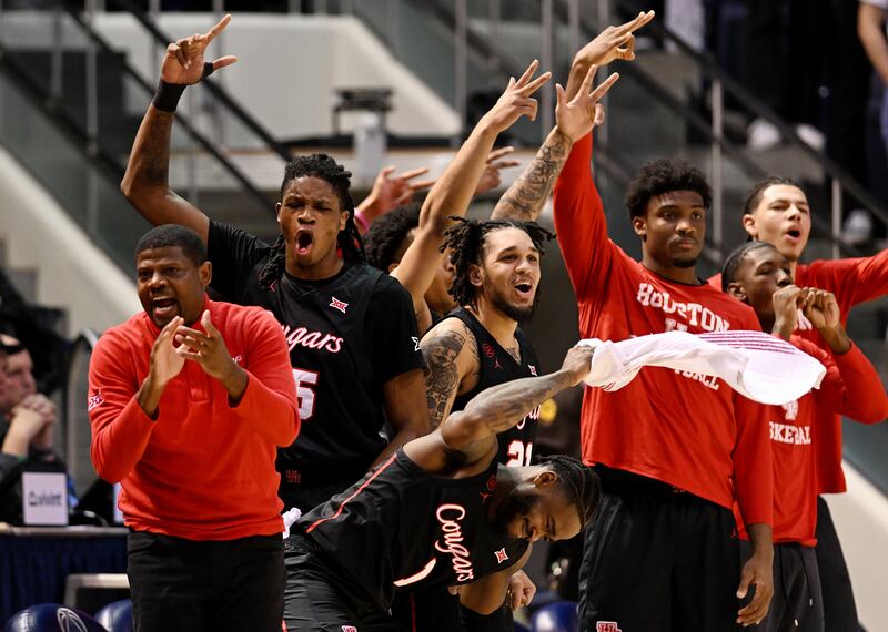 Houston Cougars players and coaches celebrate after a 3-point shot as BYU and Houston play at the Marriott Center in Provo on Tuesday, Jan. 23, 2024. Houston won 75-68.