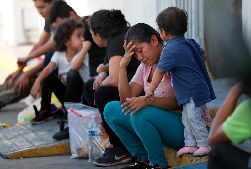 Migrants wait at an immigration center on the International Bridge 1, in Nuevo Laredo, Mexico, on July 16, 2019.