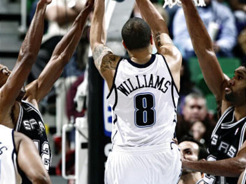 Utah's Deron Williams, 8, drives to the hoop as Spurs' Bruce Bowen, left, and Tim Duncan defend.