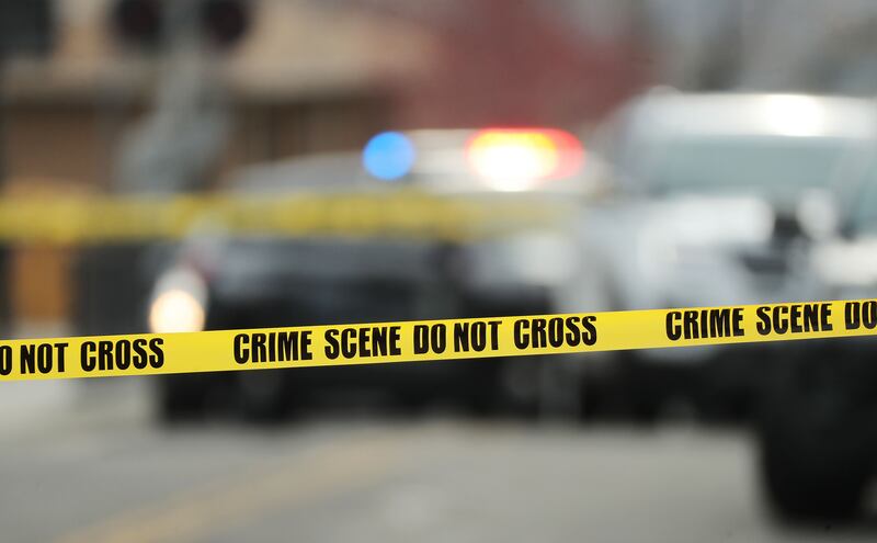 Police tape hangs at the scene after a shooting in Sandy on Friday, April 16, 2021.