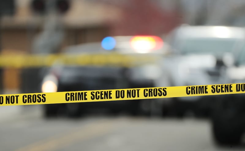 Police tape hangs at the scene after a shooting in Sandy on Friday, April 16, 2021.