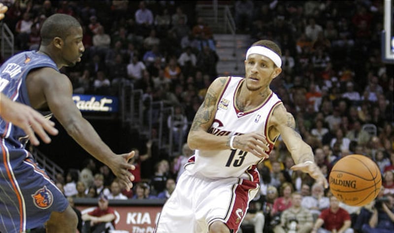 Cavaliers’ Delonte West, right, passes by Bobcats’ Raymond Felton in his season debut.