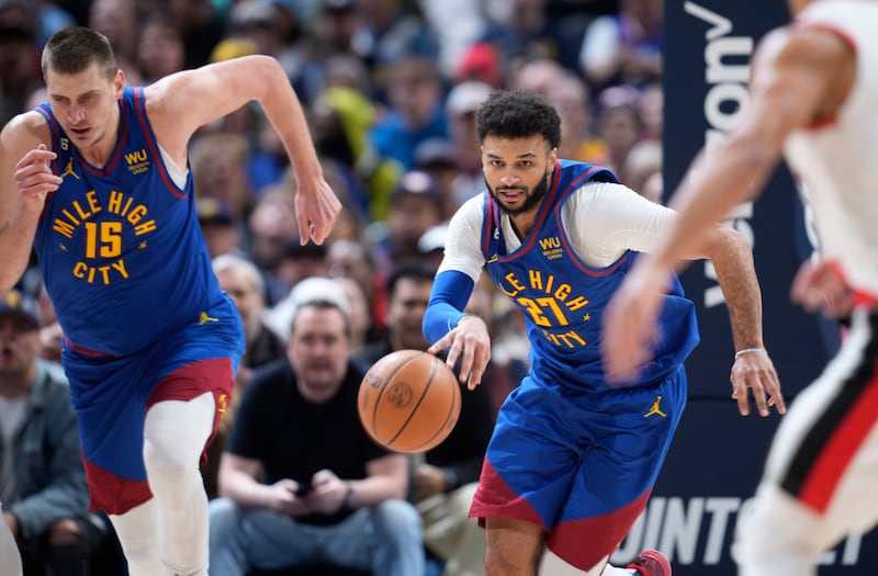 Denver Nuggets players Nikola Jokic (15) and Jamal Murray (27) in an NBA basketball game on Dec. 23, 2022, in Denver.