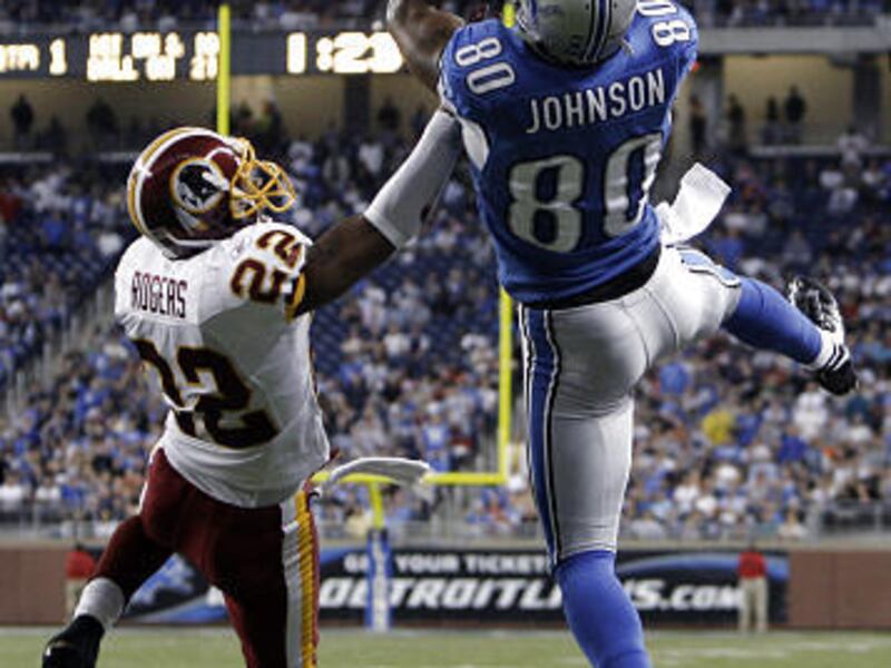 Detroit Lions wide receiver Bryant Johnson catches a 21-yard touchdown pass over Washington Redskins cornerback Carlos Rogers in the first quarter of an NFL football game in Detroit, Sunday.