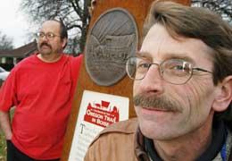 Glen Corbeil, left, and Mark Baltes show one of 17 steel Oregon Trail obelisks they placed along Boise Avenue and in North End.
