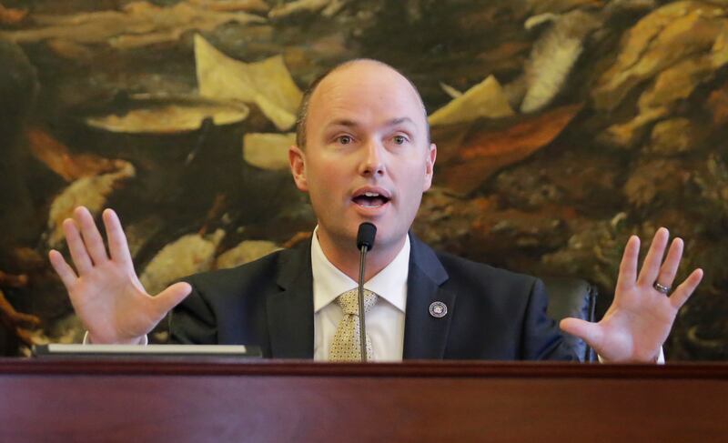 FILE - In this Dec. 19, 2016, file photo, Utah Lt. Gov. Spencer Cox speaks with protesters before Utah's six Republican presidential electors cast their votes for Donald Trump, in Salt Lake City. Cox said Thursday he looked at shutting down a political ac