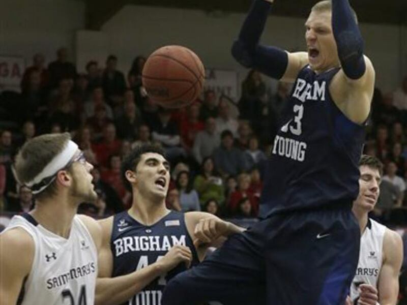 BYU forward Nate Austin, right, dunks against Saint Mary's (Calif.) during the first half of an NCAA college basketball game in Moraga, Calif., Thursday, Dec. 31, 2015. (AP Photo/Jeff Chiu)