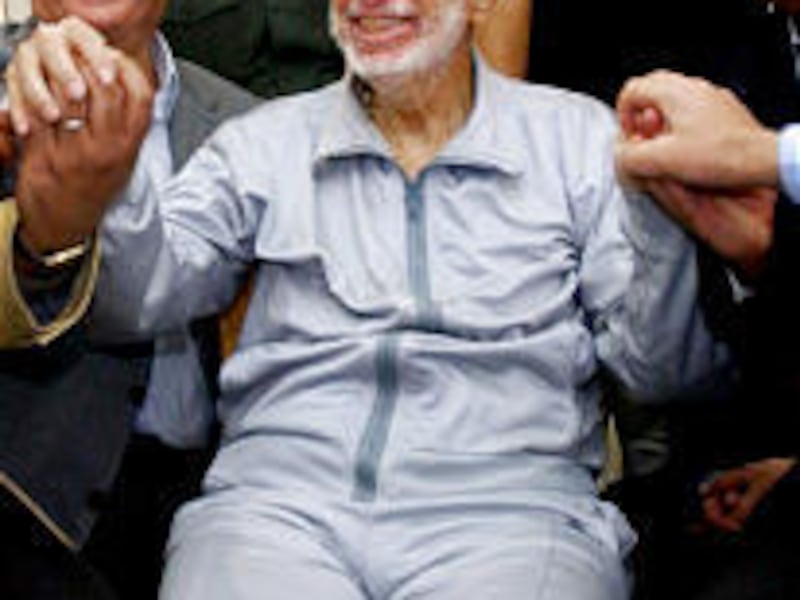 Ailing Palestinian leader Yasser Arafat, center, shakes hands with doctors at his compound in the West Bank town of Ramallah.