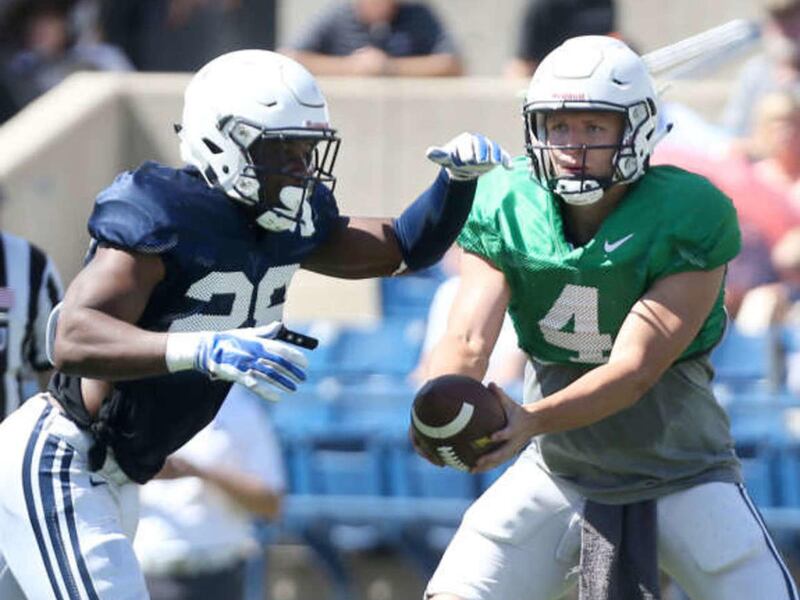 QB Taysom Hill hands the ball off to #28 Adam Hine during a scrimmage at BYU in Provo on Saturday, Aug. 15, 2015.