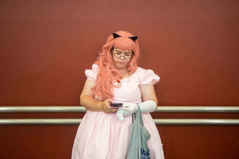 Lara Blunt, dressed as Jigglypuff, takes a look at her phone while attending FanX Salt Lake Comic Convention at the Salt Palace Convention Center in Salt Lake City on Saturday, Sept. 8, 2018.