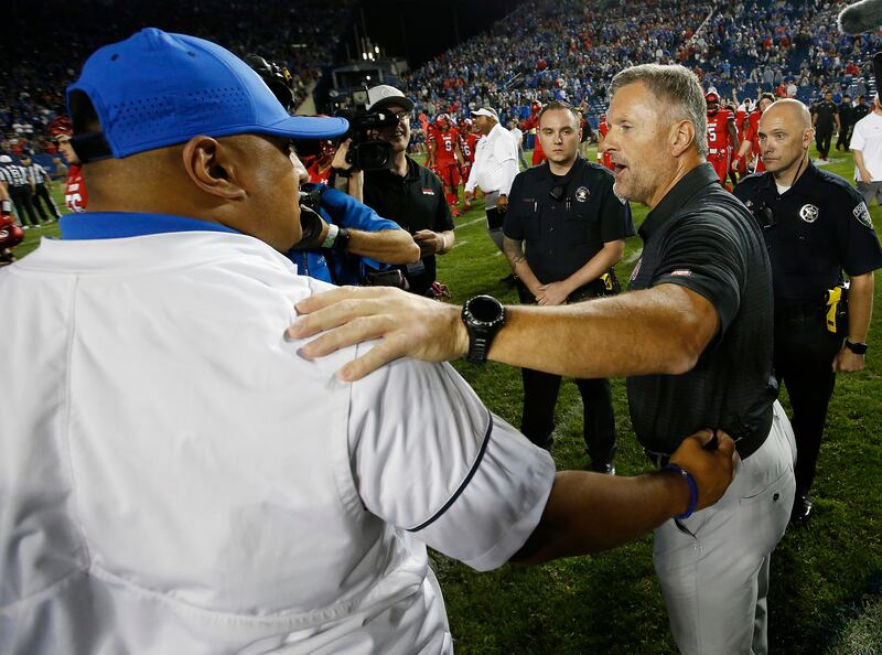 Utah coach Kyle Whittingham, right, and BYU coach Kalani Sitake greet after the game in Provo on Sunday, Sept. 10, 2017.
