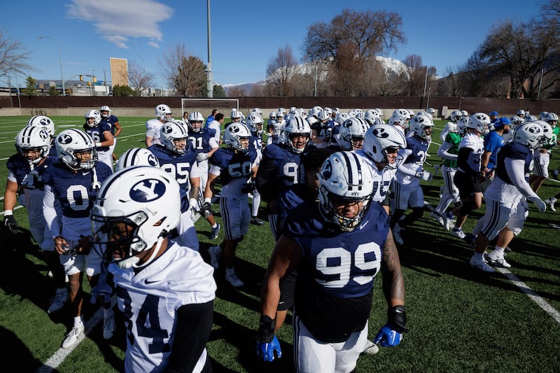 BYU players converge during spring camp practice in Provo on March 16, 2024. On Wednesday, the Cougars will hold their practice of fall camp in Provo.