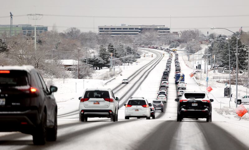 Traffic stacks up on 5300 South in Taylorsville as snow falls along the Wasatch Front on Friday, Dec. 10, 2021.