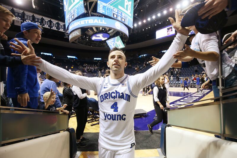 BYU guard Nick Emery high-fives fans after the BYU-USU game in Provo on Wednesday, Dec. 5, 2018. BYU won 95-80.
