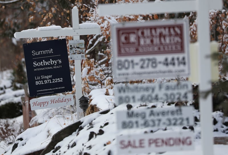 “For sale” signs are posted at properties in Salt Lake City.