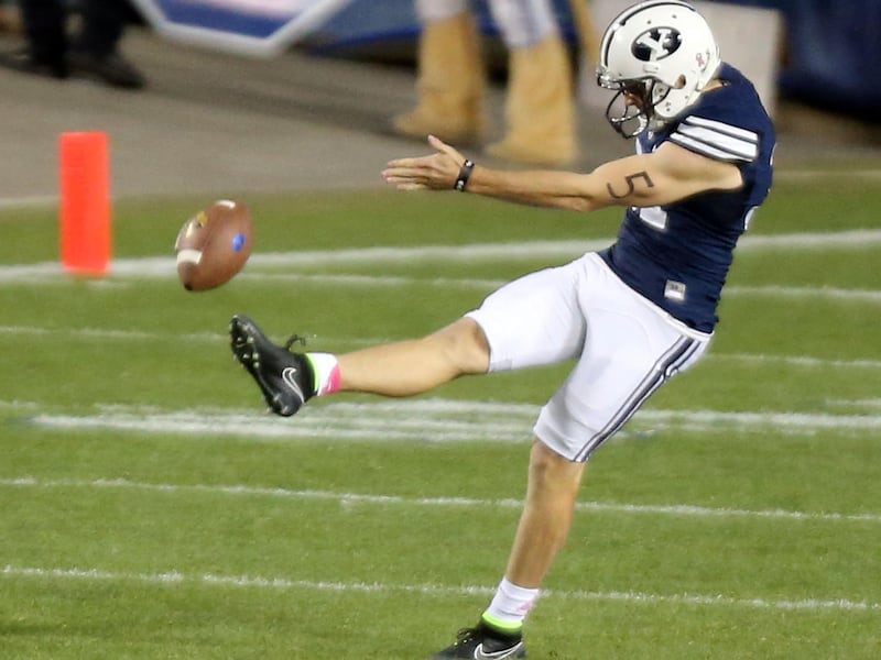 Brigham Young Cougars punter Jonny Linehan (31) kicks the ball during a football game against the Cincinnati Bearcats at the LaVell Edwards Stadium in Provo Friday, Oct. 16, 2015. BYU won 38-24.