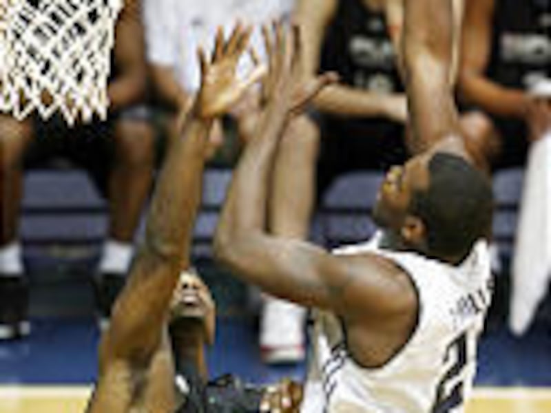 Utah's Paul Millsap shoots over San Antonio's Marcellus Sommerville.