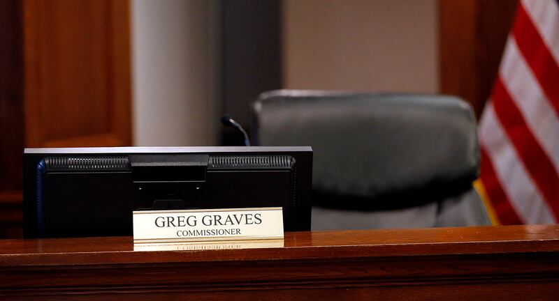 Utah County Commissioner Greg Graves' chair is empty as he participates by phone during commission meeting in Provo on Tuesday, Dec. 12, 2017.