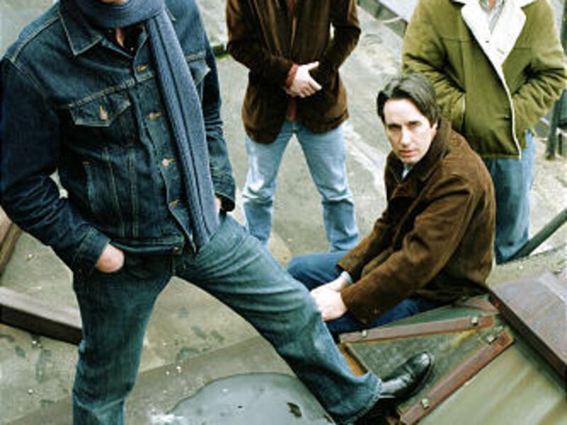 Members of the the Jayhawks, from left, Gary Louris, Marc Perlman, Stephen McCarthy, and Tim O'Reagan pose in 2003 on a roof in New York.