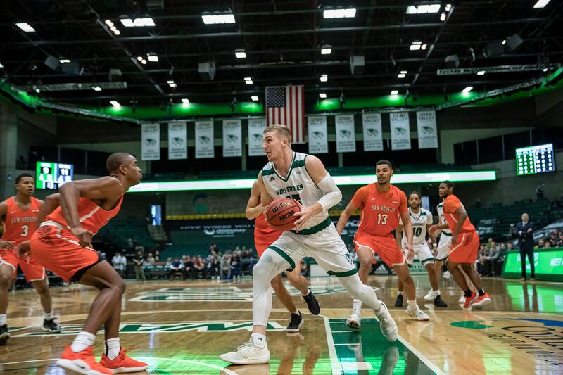 Utah Valley graduate forward Connor MacDougall (center) drives to the basket against Sam Houston State on Saturday night at the UCCU Center. MacDougall was named the WAC men's basketball player of the week for his performance in a pair of UVU home wins la