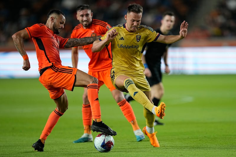 Real Salt Lake’s Danny Musovski and Houston Dynamo’s Artur battle for the ball
