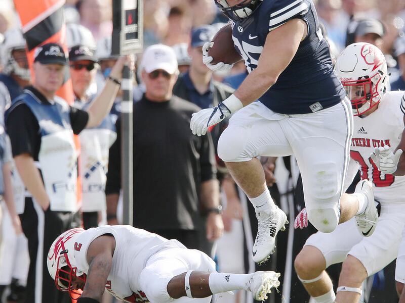 BYU tight end Nate Sampson jumps over Southern Utah Thunderbirds cornerback Josh Thornton after a catch in Provo on Saturday, Nov. 12, 2016.