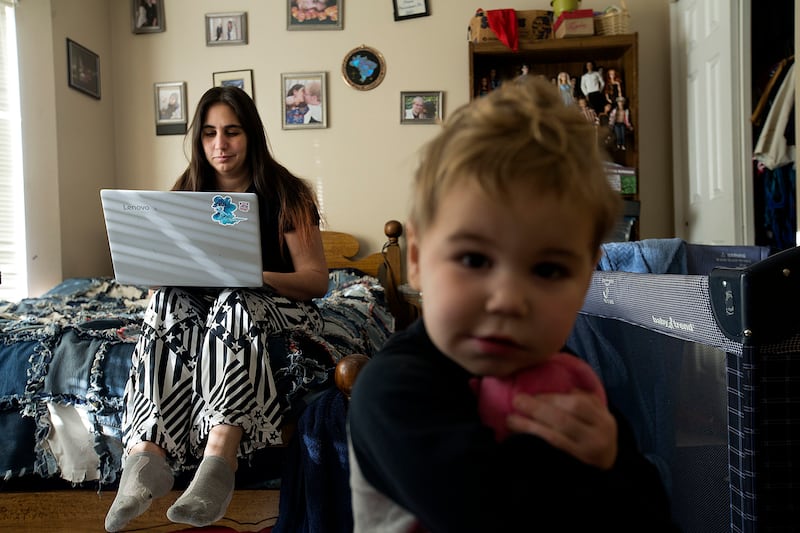 Janci Patterson, a stay-at-home writer, works on her adult romance series called “The Extra” while her son, Kenton, plays at their home in Orem on Friday, Dec. 14, 2018.