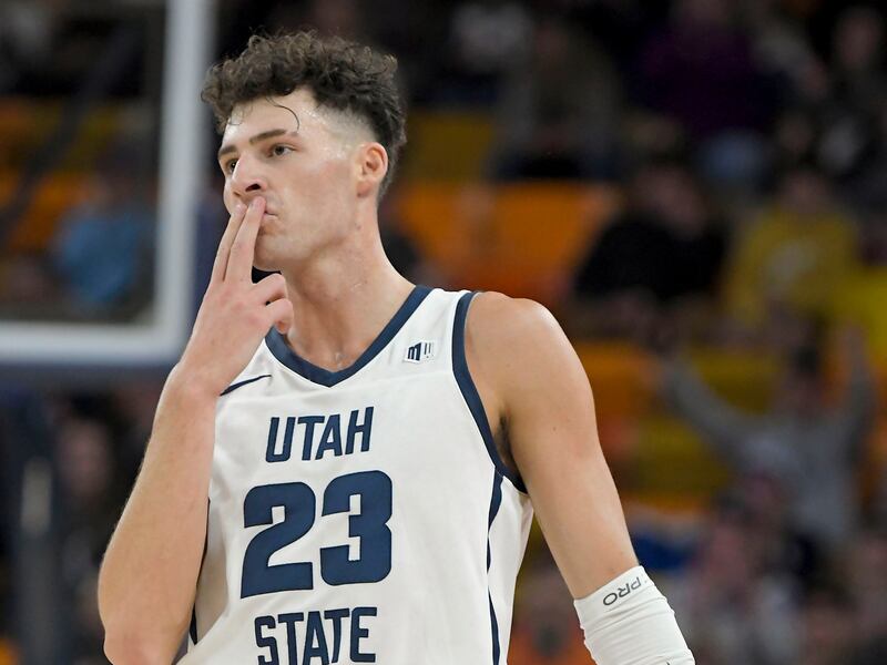 Utah State forward Taylor Funk blows a kiss after making a 3-pointer