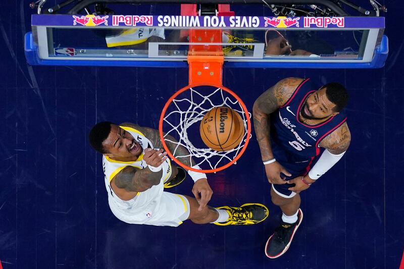 Utah Jazz’s John Collins, left, dunks next to Philadelphia 76ers’ Marcus Morris during the first half of an NBA basketball game Saturday, Jan. 6, 2024, in Philadelphia. (AP Photo/Chris Szagola)
