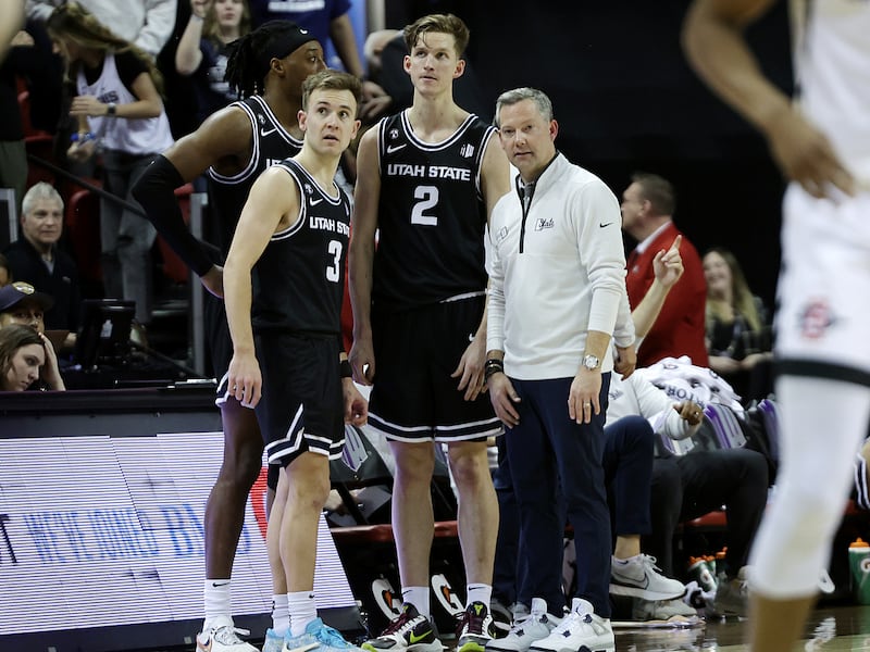 Utah State Aggies head coach Ryan Odom talks with forward Dan Akin (30), guard Steven Ashworth (3) and guard Sean Bairstow.