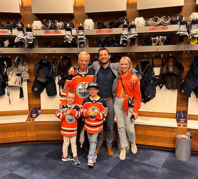Derek Ryan, with his father, Tim Ryan, left, and his wife, Bonnie, and their two children Zane and August in the Edmonton locker room.