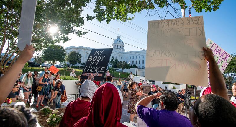 Lucia Hermo, with megaphone, leads chants during a rally against a ban on nearly all abortions, outside of the Alabama State House in Montgomery, Ala., on Tuesday, May 14, 2019. (Mickey Welsh/The Montgomery Advertiser via AP)