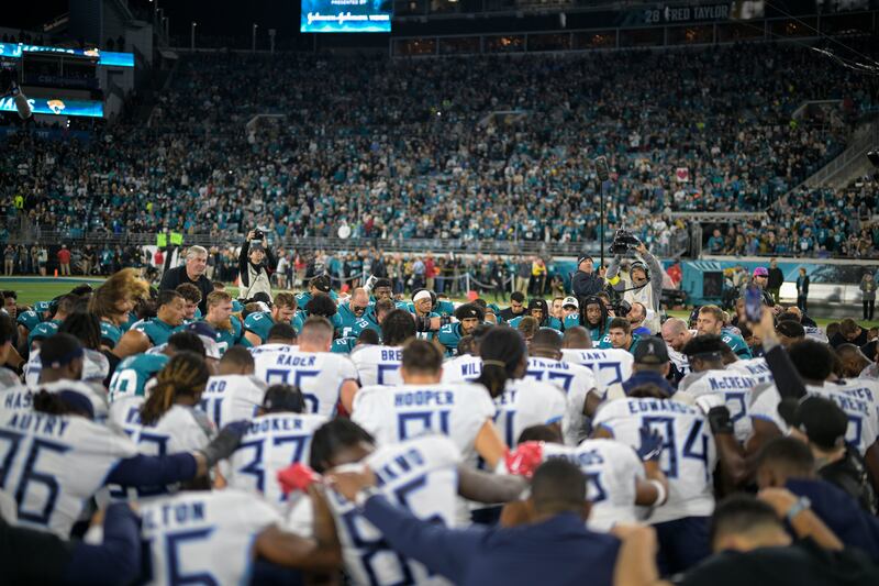 Tennessee Titans and Jacksonville Jaguars players pray for injured Buffalo Bills player Damar Hamlin, Saturday, Jan. 7, 2023, in Jacksonville, Fla.
