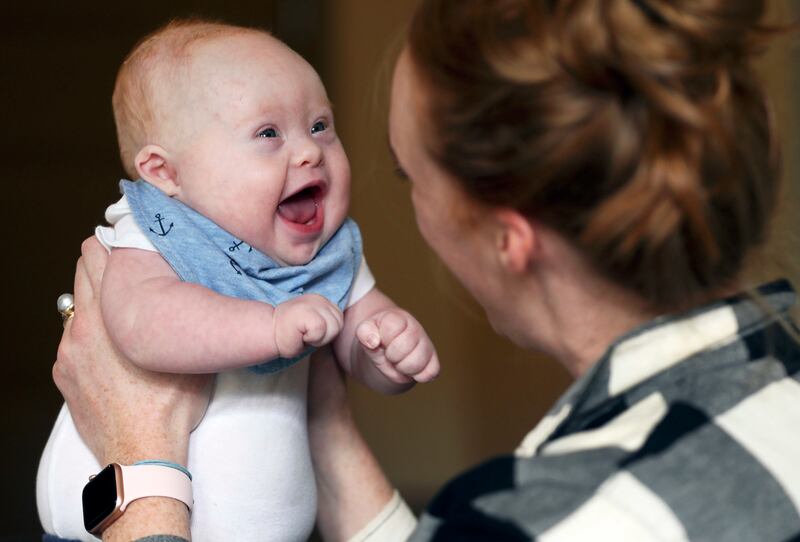 Stephanie Benton laughs with her son, Milo, as they play before his afternoon nap at their Salt Lake City home on Tuesday, March 12, 2019. Stephanie and her husband, Adam, did not know Milo had Down syndrome until he was a couple of hours old. Now they're