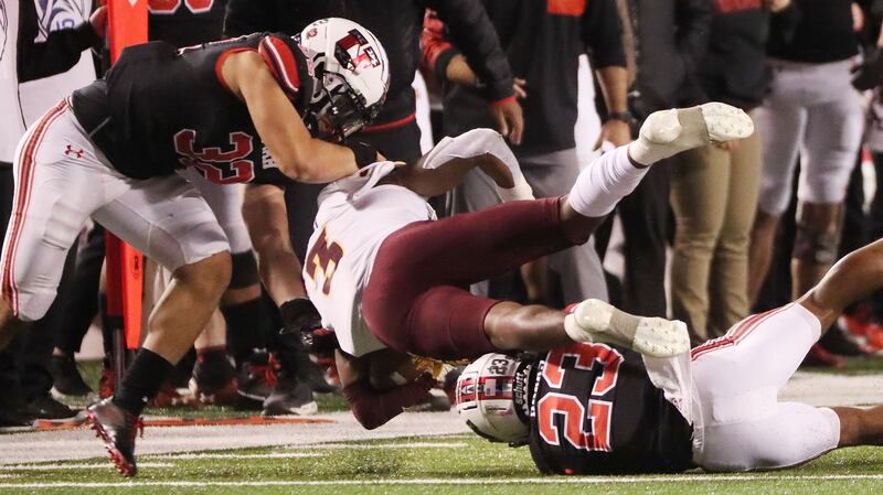 Arizona State Sun Devils running back Rachaad White is tackled by Utah Utes cornerback Faybian Marks and Utes linebacker Karene Reid