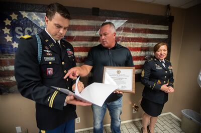 U.S. Army Capt. Villard Phillips talks with President of Sorensen Companies, Inc. Chad Sorensen, with 1st Sgt. Rosemary Armijo at the side, after a short ceremony as Sorensen Companies, Inc. partners with the U.S. Army to attract, train and deploy talente