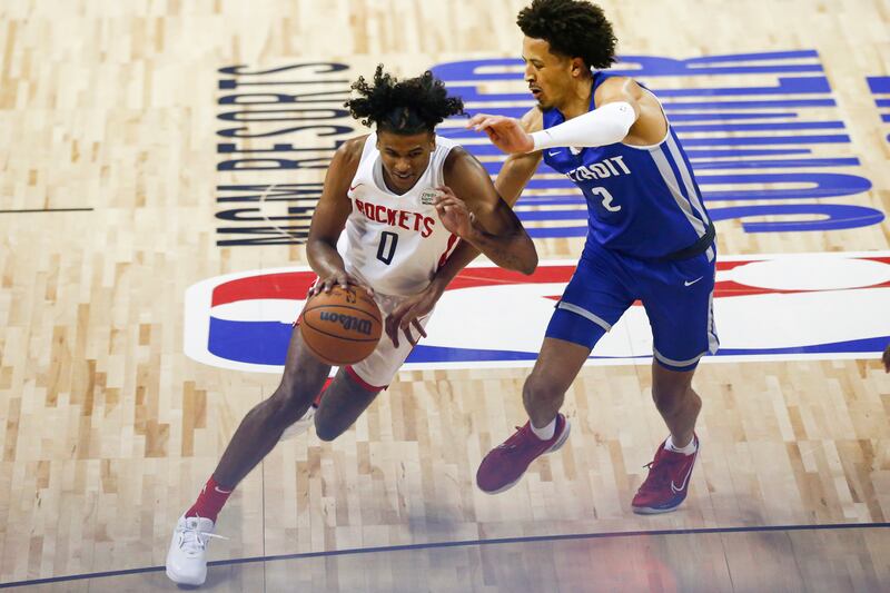 Houston Rockets’ Jalen Green (0) drives to the basket under pressure from Detroit Pistons’ Cade Cunningham (2).