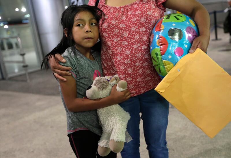 Buena Ventura Martin-Godinez, right, stands with her daughter Janne after being reunited at Miami International Airport, Sunday, July 1, 2018, in Miami. Martin crossed the border into the United States from Mexico in May with her son, fleeing violence in