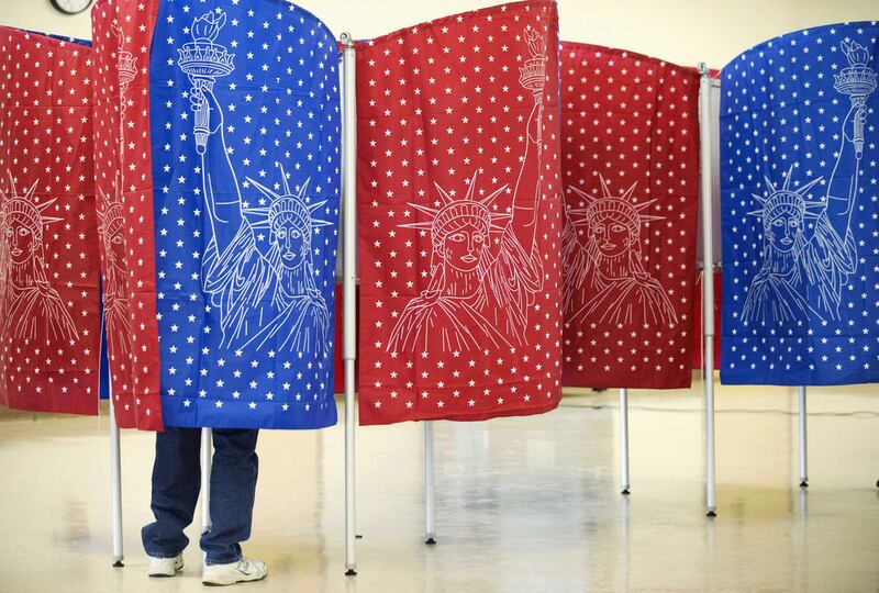 A voter marks a ballot for the New Hampshire primary inside a voting booth at a polling place Tuesday, Feb. 9, 2016, in Manchester, N.H. (AP Photo/David Goldman)