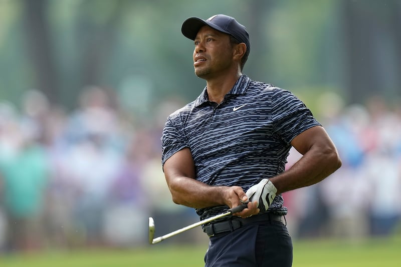 Tiger Woods hits from the fairway on the 13th hole during the first round of the PGA Championship.