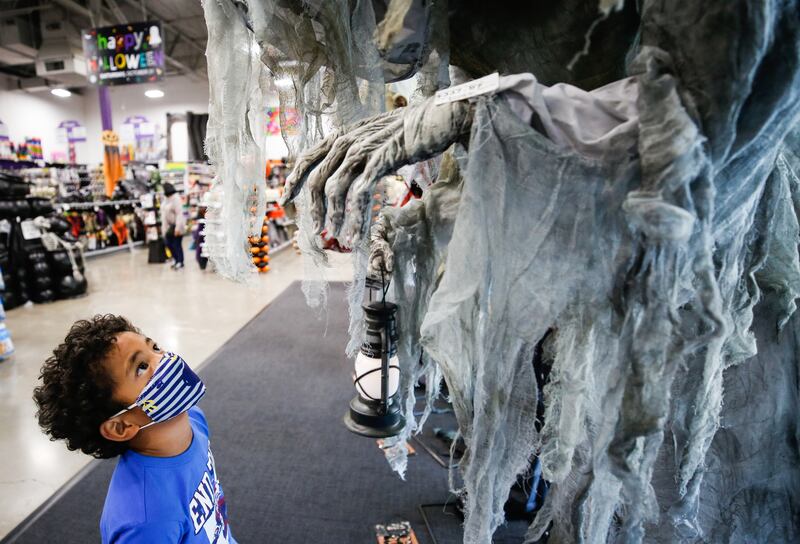 Shane Manu, 6, looks at a Halloween decoration at Zurchers, a costume and party supply store, in Salt Lake City on Friday, Oct. 16, 2020.