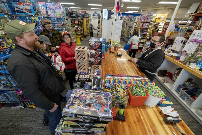 Casey Sartain talks with customers at the Tutoring Toy store in Salt Lake on Monday.