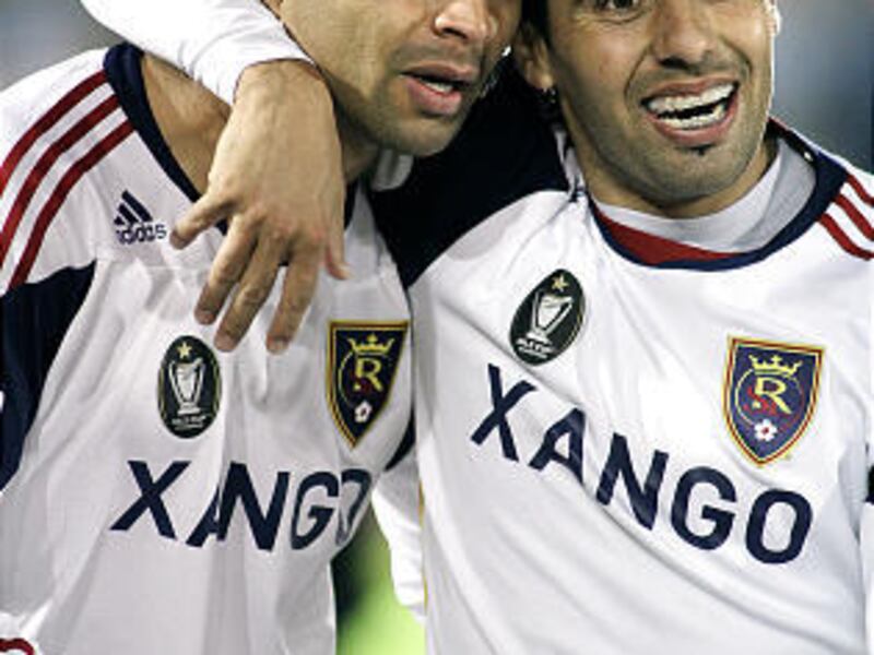 Alvaro Saborio #15 of Real Salt Lake gets a hug from teammate Javier Morales #11 after Saborio scored on a penalty shot in stoppage time to tie the game 2-2 against the Colorado Rapids at Dick's Sporting Goods Park October 23, 2010 in Commerce City, Color