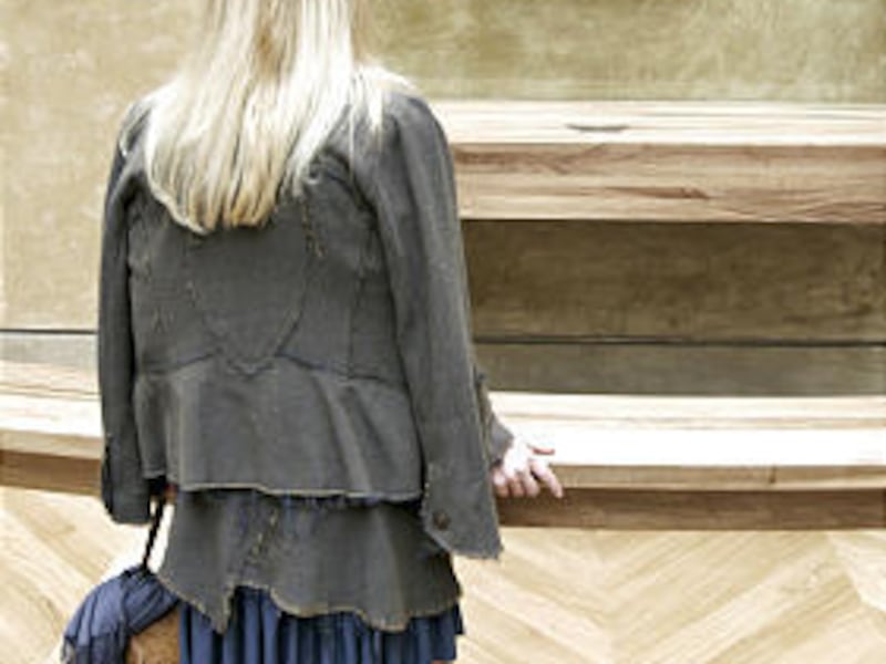 In this April 5, 2005 file photo, a woman watches the painting 'Mona Lisa' by Leonardo Da Vinci in the Louvre Museum in Paris. The Louvre Museum says Tuesday a Russian visitor hurled an empty terra cotta mug at the Da Vinci masterpiece on Aug. 2, 2009. Th